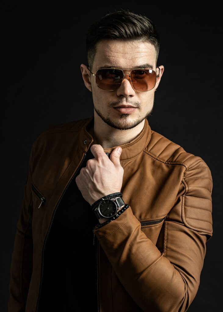 Influencer Anthony Locke wears brown jacket and sunglasses